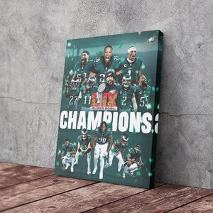 May include: A green and white poster with a group of football players celebrating. The players are wearing green and white uniforms and holding a trophy. The poster says "SUPER BOWL CHAMPIONS" in white letters.