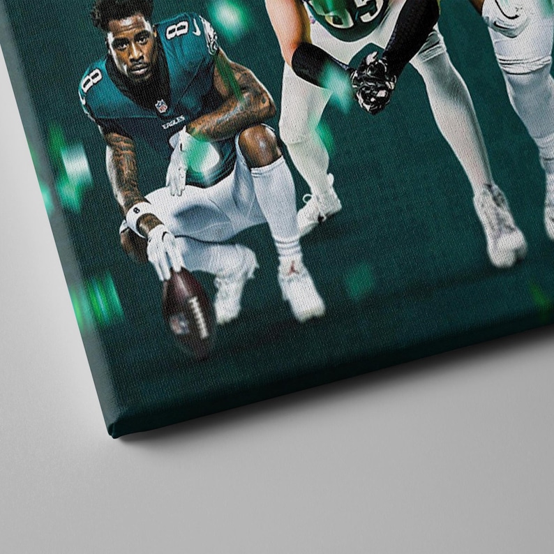 May include: A green and white football jersey with the word "EAGLES" on the front. Three football players are wearing the jersey in a dynamic pose. The background is a dark green with green and white lights.