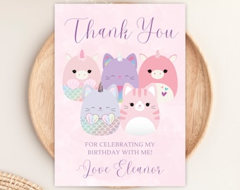May include: Thank you card with a pink background and a group of five cartoon characters. The characters are a unicorn, a cat, and three mermaid cats. The text on the card reads "Thank You" and "For celebrating my birthday with me! Love Eleanor".