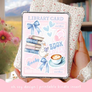 May include: A pink Kindle insert with a library card design. It features illustrations of books, blue bows, hearts, a goose reading, and a coffee cup. Text includes "LIBRARY CARD," "BOOK LOVER," and "Books." The bottom reads "oh soy design | printable kindle insert."