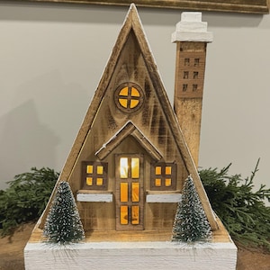 Cabaña de madera natural LED de 24 x 12 x 29 cm con temporizador, ideal para decorar una aldea navideña.