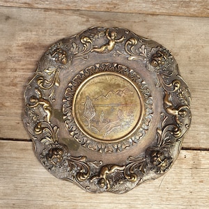 Vintage Brass and Pewter Italian plate with lion heads and cherubs