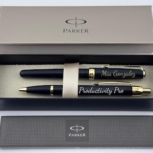May include: A black Parker pen and pencil set with gold accents, presented in a gift box. The pen is engraved with "Mia Gonzalez," and the pencil reads "Productivity Pro." The set includes a matching box and a card with the Parker logo.