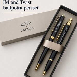 May include: A Parker IM and Twist ballpoint pen set in a presentation box. The black pens feature gold-tone accents and clips. One pen is engraved with the name Kevin Peterson, and the other with the phrase Forever proud of you.