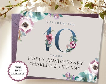 May include: A light gray card with a blue number 10 decorated with watercolor flowers. The text "Celebrating 10 Years Happy Anniversary Charles & Tiffany" is printed on the card.