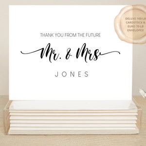 May include: A stack of white thank you cards with a black wax seal. The cards have the text "Thank you from the future Mr. & Mrs. JONES" printed on them.