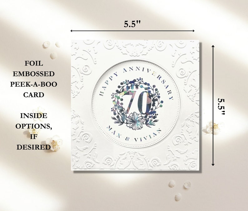 May include: A white card with a 5.5 inch by 5.5 inch design. The card features a white circle with the text "Happy Anniversary" and the number "70" in a colorful wreath. The text "Max & Vivian" is below the wreath. The card has a foil embossed peek-a-boo design.