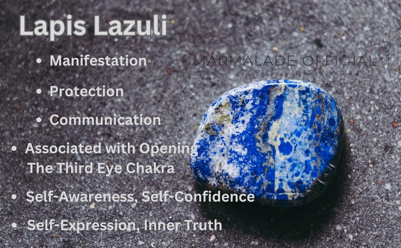 May include: A close-up of a Lapis Lazuli stone with white text listing its properties: Manifestation, Protection, Communication, and more. The stone is a deep blue color with white and gold veining, set against a textured gray background.
