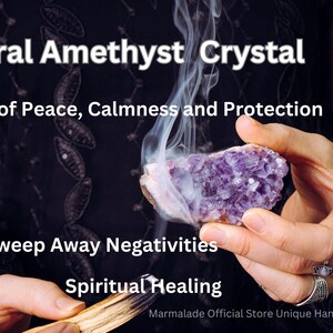 May include: A natural amethyst crystal is held in a person's hand, with smoke rising from it. The image includes text that reads "Natural Amethyst Crystal", "Stone of Peace, Calmness and Protection", "Sweep Away Negativities", and "Spiritual Healing".