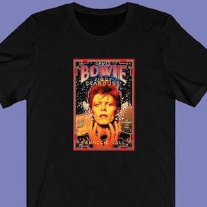 May include: Black t-shirt with a colorful image of David Bowie, the text "David Bowie", "Ziggy Stardust", and "Carnegie Hall".