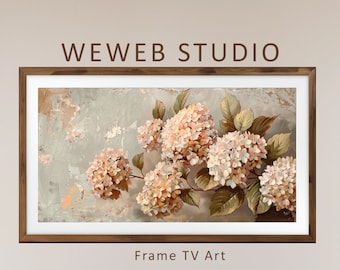 May include: A framed artwork featuring a floral still life with soft pink and white hydrangea blooms. The painting is set against a textured, muted gray background. The frame is a dark wood. The text "WEWEB STUDIO" and "Frame TV Art" are visible.