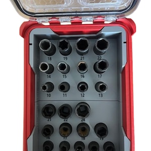 May include: A red and grey socket set with a clear lid. The set contains various sized sockets, labelled with numbers from 10 to 24. The sockets are arranged in a red plastic case with a clear, hinged lid.
