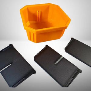 May include: A bright orange plastic storage bin with a hexagonal shape and three separate black rectangular dividers. The bin features vertical interior slots designed to hold the dividers in place, creating organised compartments within the container.