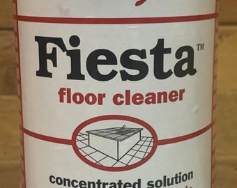 May include: A white bottle of Stanley Home Products Fiesta floor cleaner with red text and graphics. The label features the brand name, product name, a line drawing of a tiled floor, and the text concentrated solution and citrus burst fragrance.
