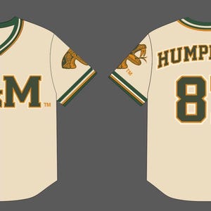 May include: A cream-colored baseball jersey featuring green and gold trim on the collar and sleeves. The front displays the text A&M in green, while the back shows the name HUMPHRIES and the number 87 in green with gold outlines.