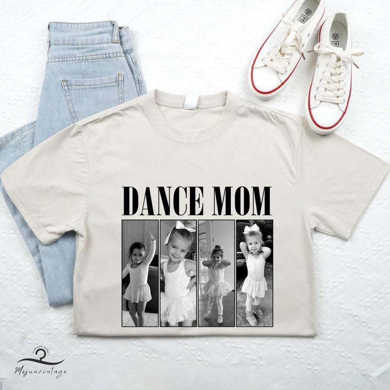 May include: A beige t-shirt with the text "Dance Mom" printed in black. The shirt features three black and white photos of young girls in dance attire.