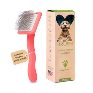 May include: Pink pet slicker brush with a wooden handle and silver bristles. The brush is labeled "PET SLICKER BRUSH" and "eco-friendly, handmade wooden brush". The packaging also includes the brand name "FLYING PAWFECT" and the size "SMALL".