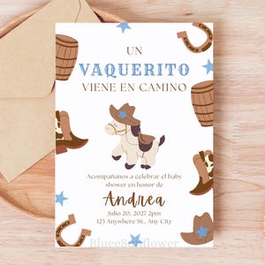 May include: A baby shower invitation with a cowboy theme. The invitation features a cartoon horse wearing a cowboy hat, boots, barrels, horseshoes, and stars. The text reads "Un Vaquerito Viene En Camino" and invites guests to celebrate Andrea's baby shower.