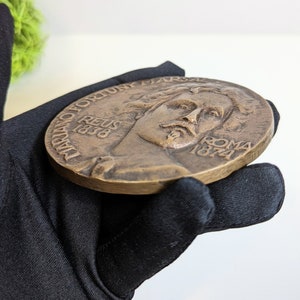 May include: A bronze medal with a portrait of a man on one side and the text "D.D. FORTUNY. REUS 1838 ROMA 1874" on the other side.