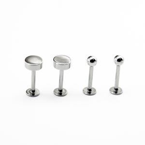 May include: Four silver body jewellery pieces, including two flat-top labret studs and two ball-top labret studs.