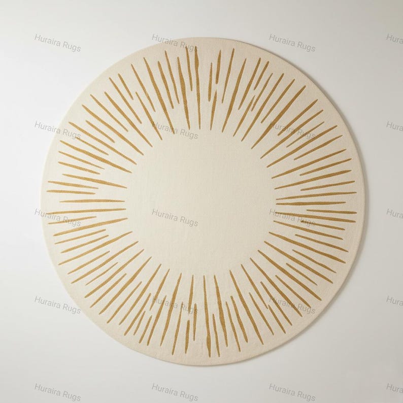 May include: A circular rug in cream with a sunburst pattern. The rug has a central cream circle, encircled by radiating golden-brown lines. The lines are evenly spaced, creating a striking pattern. The rug is likely made of a soft material, with a diameter of approximately 150 cm.