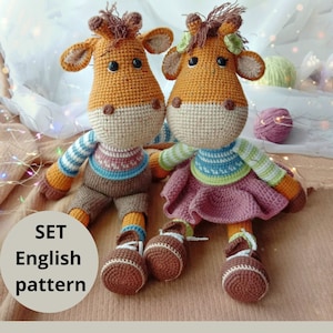 May include: A crochet pattern set for two amigurumi giraffe toys. The giraffes are brown and orange with blue and green striped shirts and brown shoes. The pattern is in English.