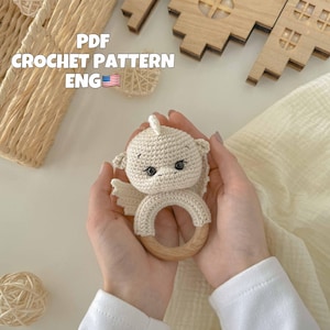 Peut inclure: Hochet bébé en crochet avec une tête de dragon blanche en crochet et un anneau en bois. Patron de crochet PDF inclus. ENG.