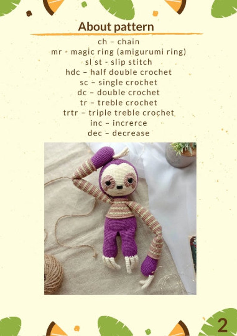 May include: Purple and brown crocheted sloth amigurumi toy. The toy is sitting on a beige fabric surface. The toy has a sleepy expression and is holding its arm up to its head. The toy is made with a single crochet stitch and has a striped pattern on its arms and torso.