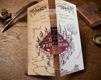 May include: A gatefold wedding invitation featuring a cream-colored parchment design with dark brown ink illustrations of a castle, winding paths, and the text Karl David Hurst and Benjamin Thomas Jones are proud to present their wedding.