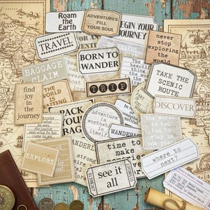 May include: A collection of vintage-style travel-themed paper tags with phrases like "Roam the Earth," "Born to Wander," and "See it All." The tags are in various shapes and sizes, with a distressed, aged appearance, and are scattered on a map.