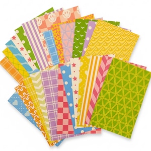 May include: A collection of colorful patterned paper sheets fanned out against a white background. The sheets feature various designs, including stripes, polka dots, stars, and geometric shapes in shades of pink, green, yellow, blue, and purple. The paper is likely for crafts or scrapbooking.