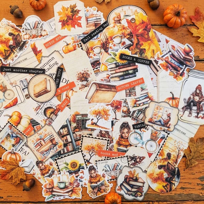 May include: A collection of autumn-themed paper ephemera and stickers featuring illustrations of books, pumpkins, falling leaves, sunflowers, bicycles, and people reading. The designs include text labels like 'fall reading day', 'books & coffee', and 'autumn leaves'.