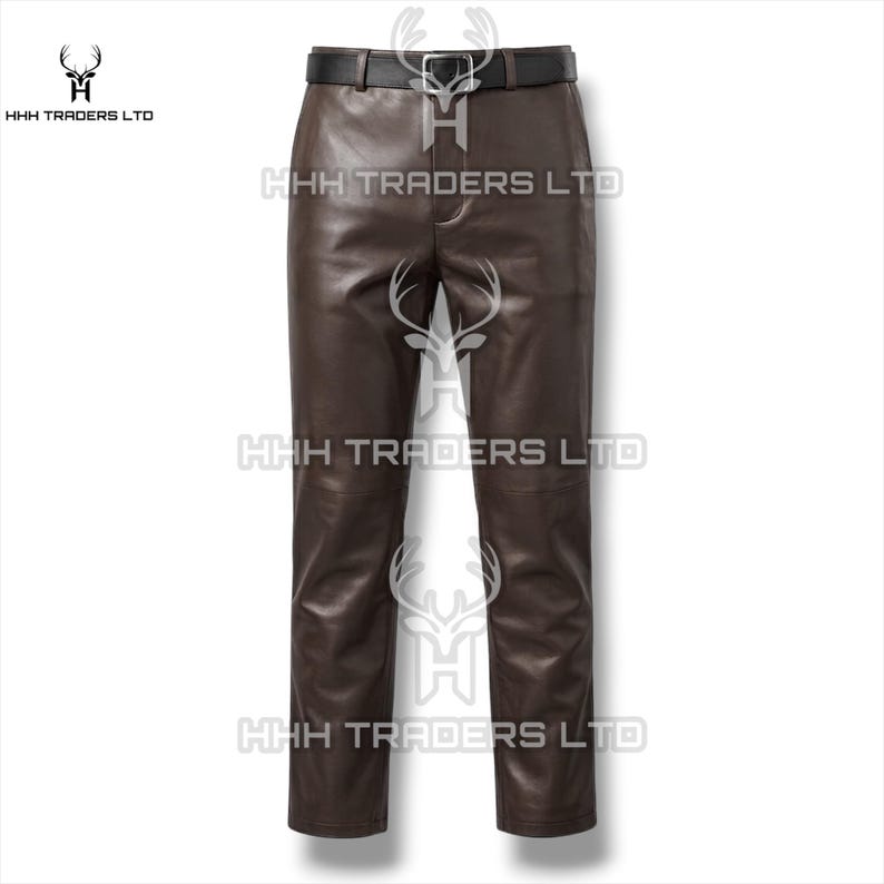 May include: Dark brown leather trousers featuring a smooth finish, a straight-leg cut, and a black belt with a silver-toned metal buckle at the waist. The garment includes a central fly closure and is branded with the text HHH TRADERS LTD.