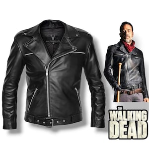 May include: Black leather jacket with a silver zipper, belt, and multiple pockets. The jacket has a classic biker style with a notched collar and a fitted silhouette. The Walking Dead logo is visible in the image.