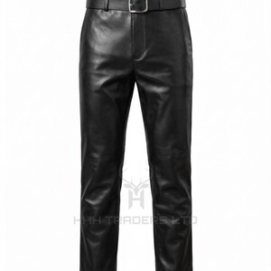 May include: Black leather trousers featuring a smooth finish, a straight-leg cut, and a matching black leather belt with a silver-toned metal buckle. The garment includes a central fly closure and belt loops, with the text HHH TRADERS LTD visible.