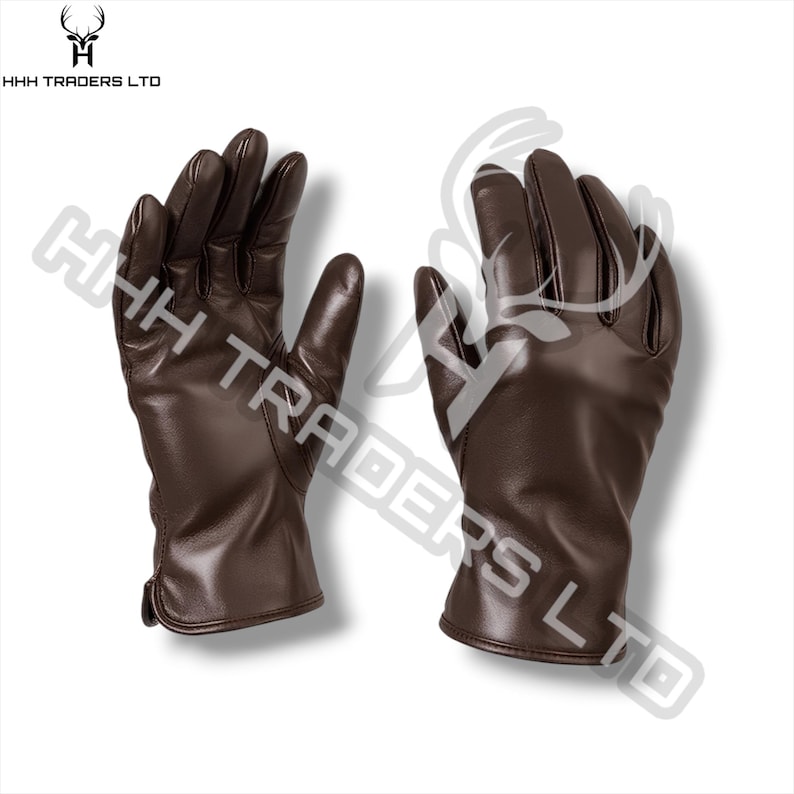May include: A pair of dark brown leather gloves with visible stitching along the fingers and palms. The gloves feature a smooth finish and a simple cuff design. The text HHH TRADERS LTD is visible in the top left corner and as a watermark.