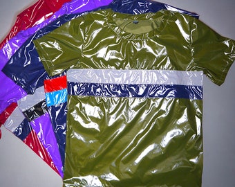 May include: A stack of five shiny, colorful t-shirts. The top shirt is a green, short-sleeved t-shirt with a reflective silver and navy blue stripe across the chest.