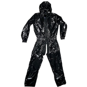 May include: A shiny black jumpsuit with a hood and a full-length zipper. The one-piece garment has long sleeves and elasticized waist and ankles. The material has a reflective, wet look.