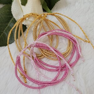 Multi-string adjustable bracelet. Fucsia and gold galvanized seed beads Miyuki.