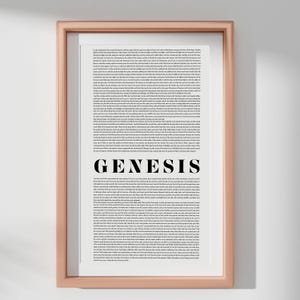 May include: A framed print with a rose gold frame. The print features the text of Genesis in a black font on a white background. The word "GENESIS" is prominently displayed in a bold, sans-serif font.