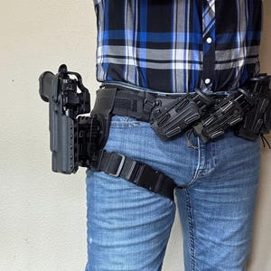 Level ll holster w/ hood for most duty pistols w/ or w/o weapon mounted light, carries on G-code Optimal Drop Platform Hanger w/ thigh strap
