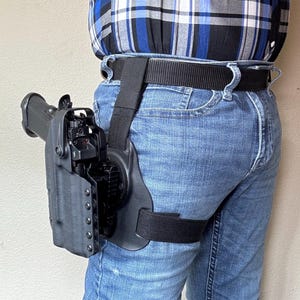 Level ll holster w/ hood for most duty pistols w/ or w/o weapon mounted light comes w/ G-Code thigh mule leg harness for tact drop leg carry