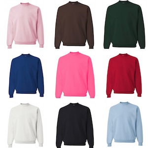 May include: Nine crew neck sweatshirts in a variety of colours, including pink, brown, green, blue, neon pink, red, white, black, and light blue.