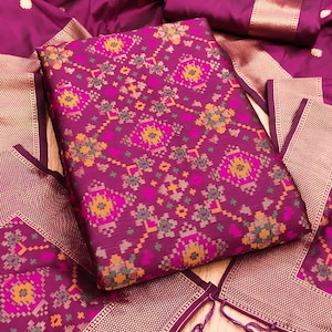 May include: A rich purple fabric set featuring a detailed geometric pattern in yellow, green, and pink. The set includes a main fabric piece, a matching fabric piece, and decorative borders with gold accents. The fabric has a luxurious sheen.