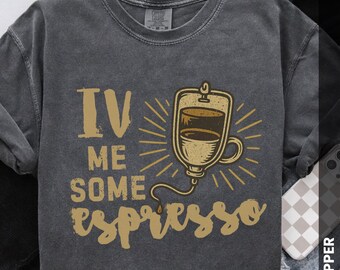 May include: Dark gray t-shirt with the phrase "IV ME SOME espresso" in a distressed gold font. The design includes an illustration of a coffee IV drip bag with radiating lines.