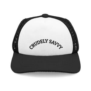 May include: A black and white trucker hat featuring a solid white front panel with the text CRUDELY SAVVY printed in a black arched font. The cap includes a black brim and black mesh side and back panels with a button on the top center.