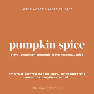 May include: An orange background with the text "WEST COAST CANDLE STUDIO&reg;" at the top. The words "pumpkin spice" are in large white letters. Below, the ingredients are listed: clove, cinnamon, pumpkin, buttercream, vanilla. The text "A warm, spiced fragrance that captures the comforting aroma of a pumpkin spice drink" is also included.