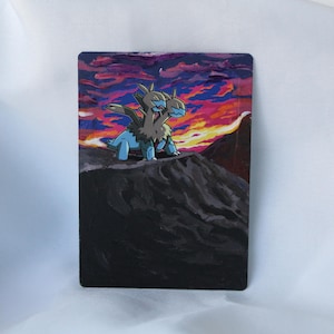 May include: A rectangular painting depicts a two-headed creature with blue and brown tones, set against a vibrant sunset sky. The creature stands atop a dark, textured mountain, with a colorful sky of pink, orange, and purple.