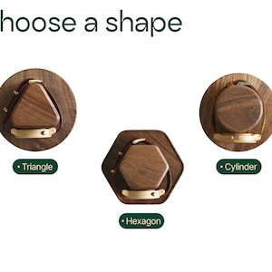 three different shapes of wooden objects, each with a unique design and color.