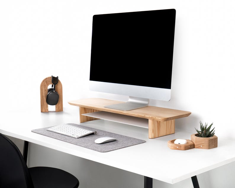 a computer monitor sitting on top of a white desk